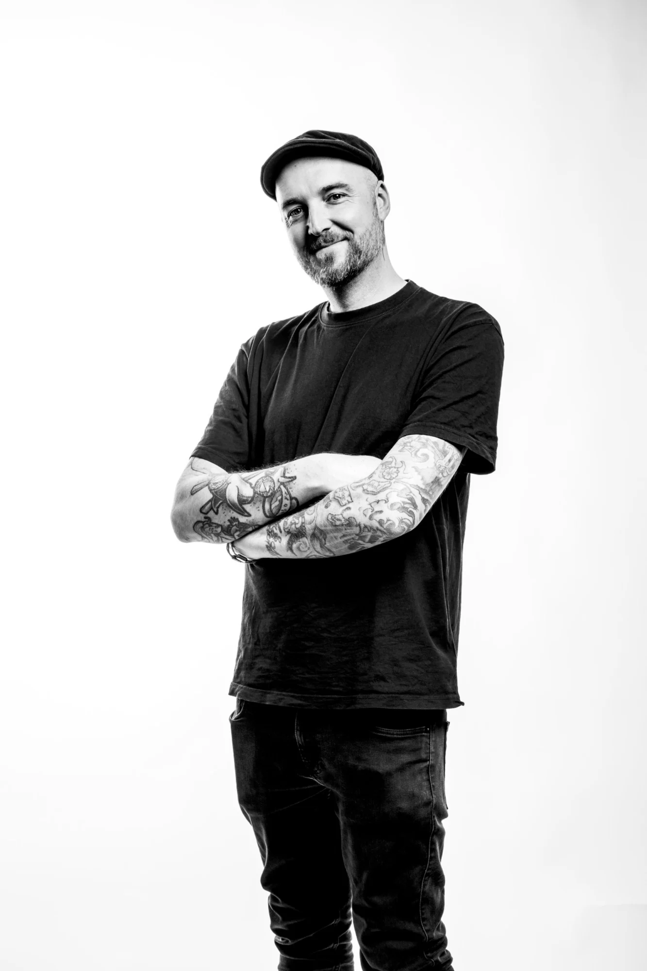 Florian Kozak, flat cap, arms crossed